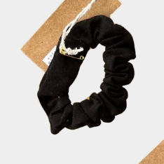 Set of colorful scrunchies with tags on a light background