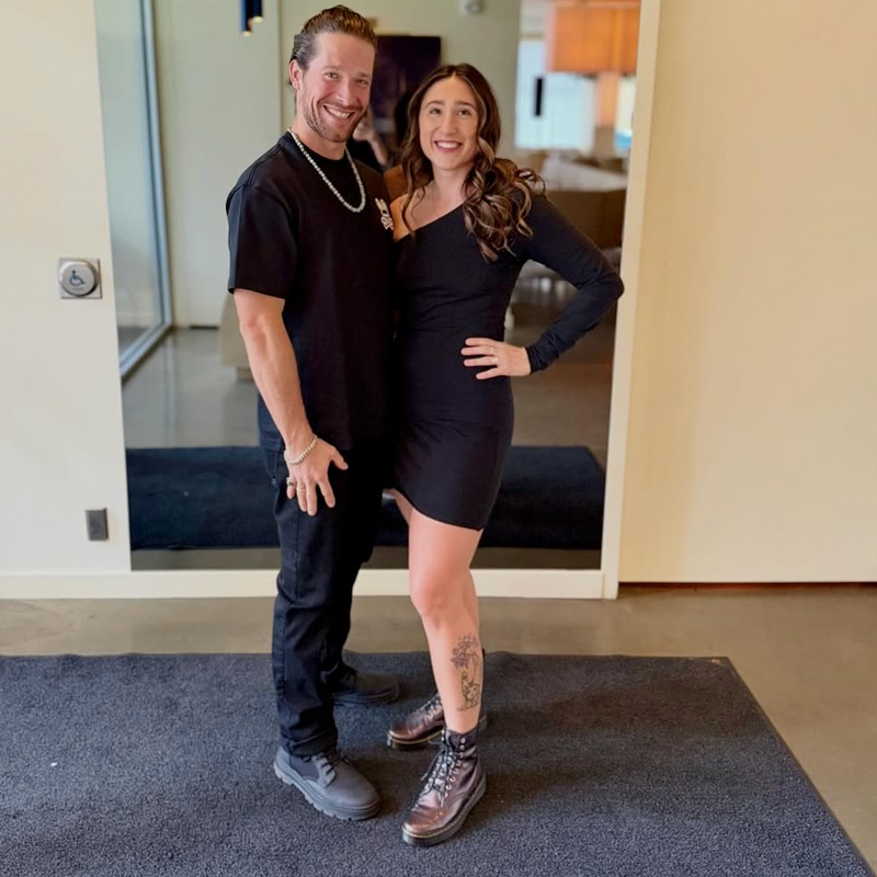 Matching Couple in Black Outfits, her wearing a mini Goddess Dress