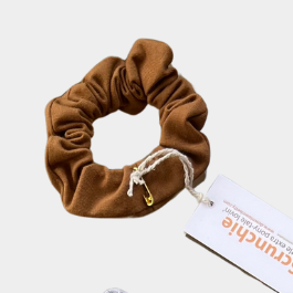 Set of colorful scrunchies with tags on a light background