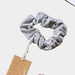 Set of colorful scrunchies with tags on a light background