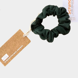 Green scrunchie with a tag on a white background