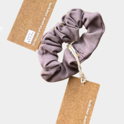 Set of colorful scrunchies with tags on a light background