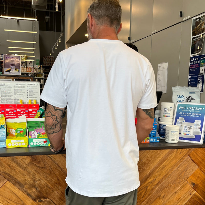 Man standing at a Body Energy counter with various products on display
